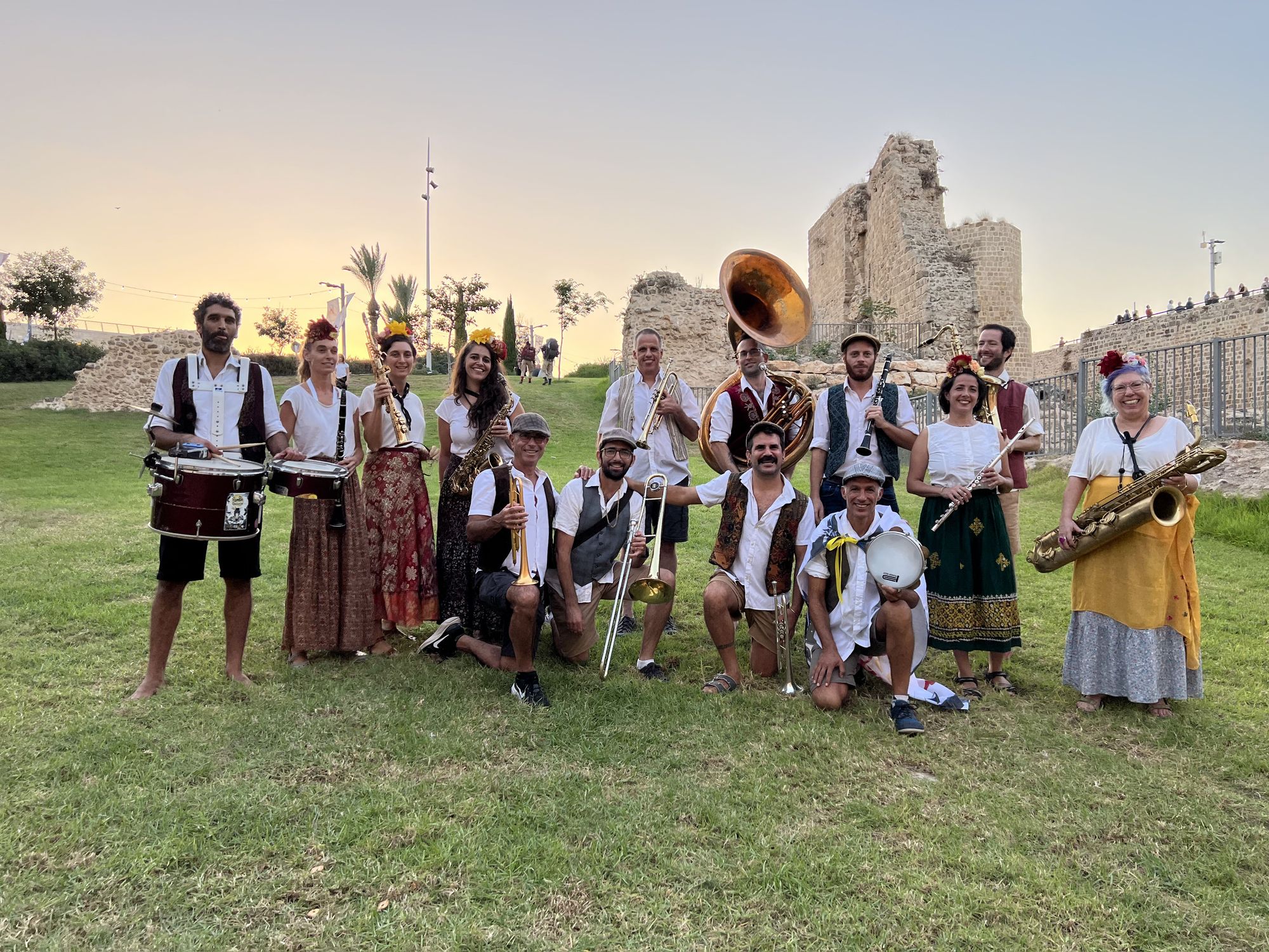 male and female gypsy musicians standing in front of an old fortress, steampunk engine, detailed matte painting, deep color, fantastical, in...