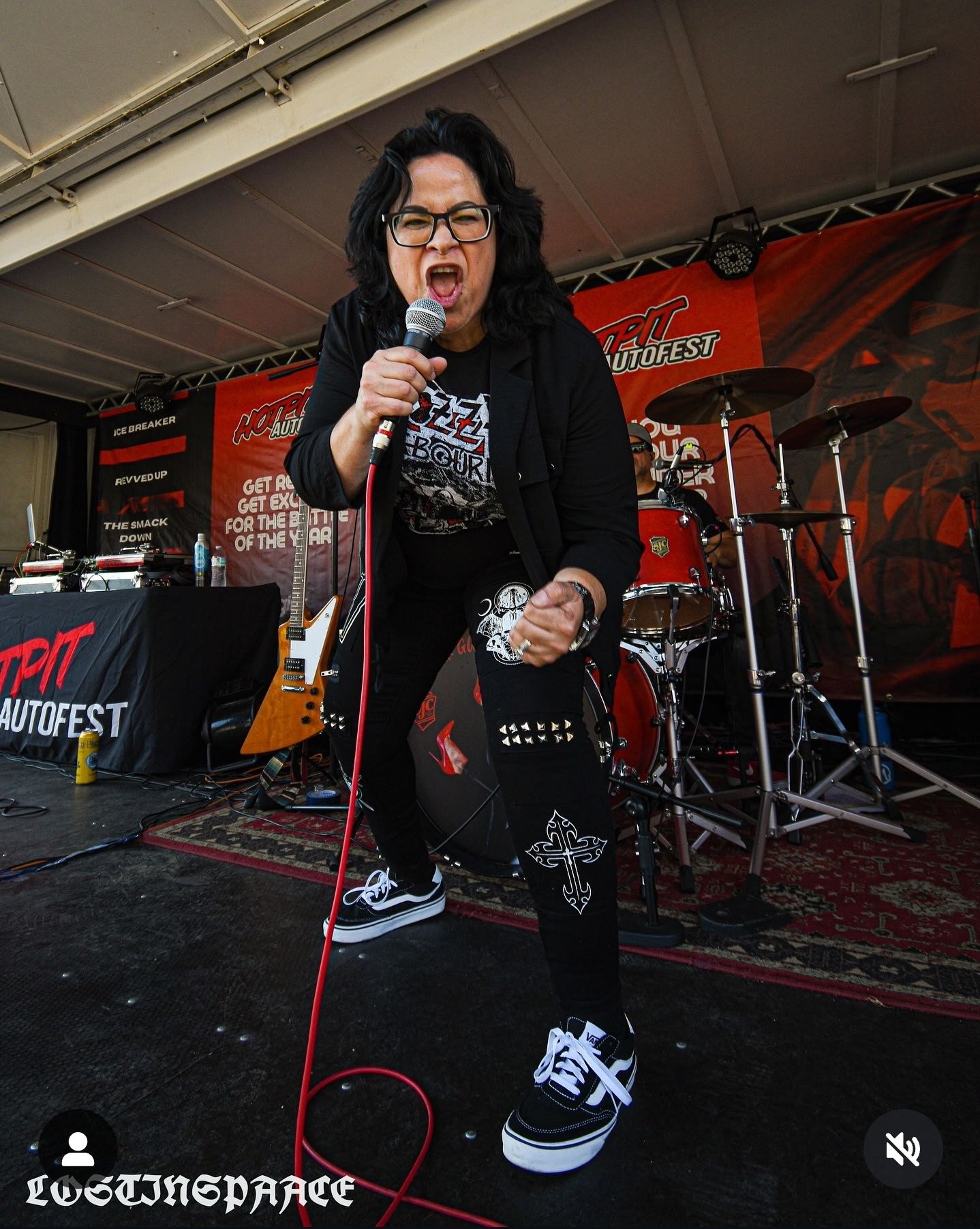 Have woman in image yelling let's rock and shake fist like Rockstar, light brown eyes, rock n roll star, remove drummer,...