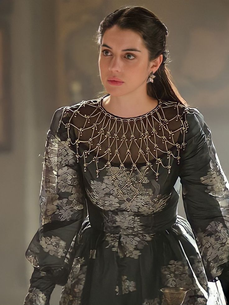 The series house of the dragon. A luxurious medieval throne room where everything looks exquisite and luxurious. There is a young queen in i...