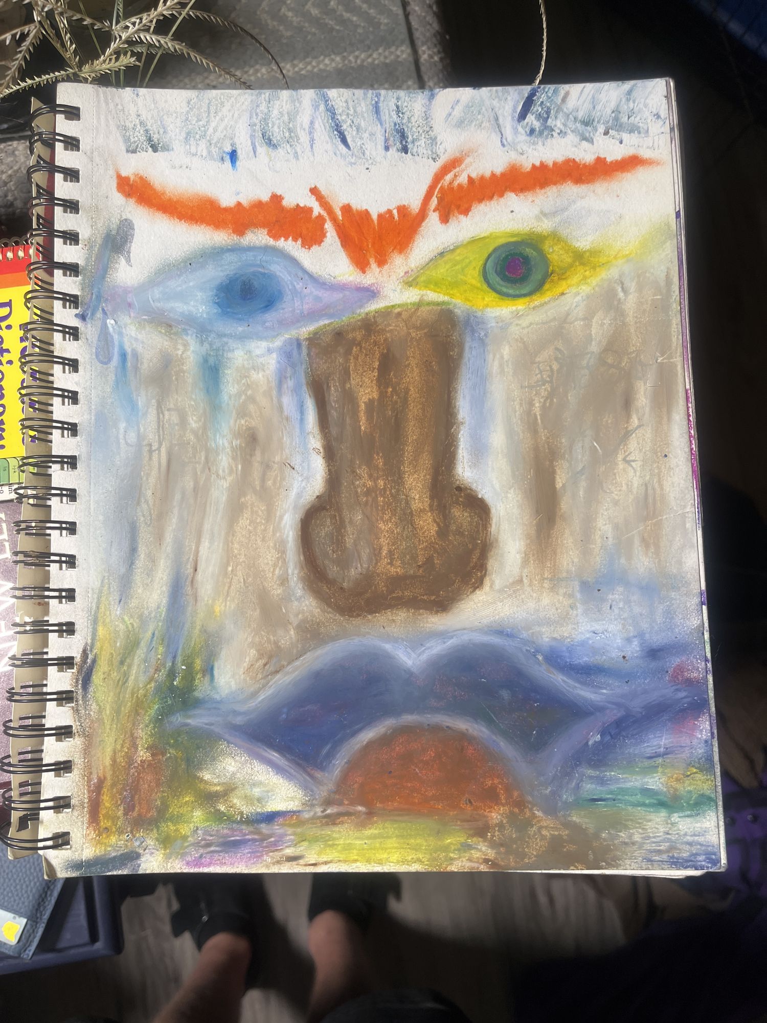 extroverted 

It’s a face where a landscape scene featuring a lonely person is sitting beside the lake. The lake is flowing out of the open mouth of the f...